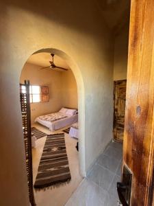a room with a bed and a mirror at Agpeninshal Ecolodge in Siwa