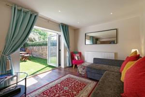 a living room with a couch and a window at Garden Oasis in Margate