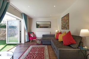 a living room with a couch and a table at Garden Oasis in Margate