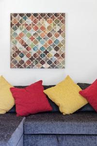 a grouping of pillows on a couch in a living room at Garden Oasis in Margate