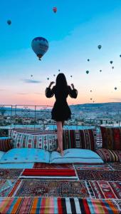 a woman standing on top of a couch on a ship at Virtus Cappadocia Hotel Göreme in Goreme