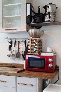 a red microwave on a counter in a kitchen at Garden Oasis in Margate