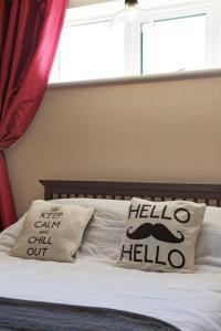 a bed with two pillows on it with a window at Garden Oasis in Margate