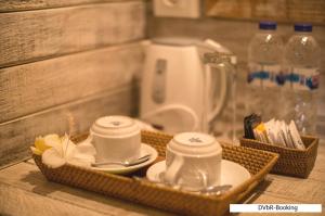 two cups and saucers sitting on a counter at Dayung Villas By Reccoma in Nusa Lembongan