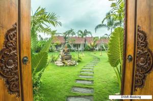 a view of a garden through a door at Dayung Villas By Reccoma in Nusa Lembongan +63 photos