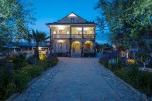 Casa grande con balcón en un jardín por la noche en Antigoni's Family House! en Zakynthos