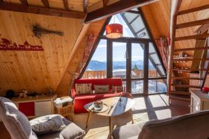 レ・ザングルにあるChalet des Pyramidesのリビングルーム(大きな窓付)