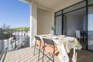 a table and chairs on a balcony with a view at Boliches in Arcos de la Frontera