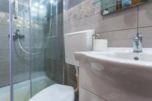 a bathroom with a toilet and a sink and a shower at Rooms Marija in Malinska +26 photos