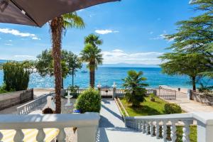 a view of the ocean from the balcony of a house at Rooms Marija in Malinska