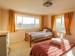 a bedroom with two beds and a window at Fairview House in Kidderminster