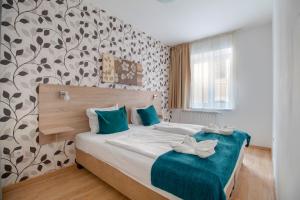 Postel nebo postele na pokoji v ubytování Prince Apartments