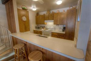 a kitchen with wooden cabinets and a counter top at Spiral Staircase home in Kings Beach
