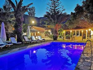 a villa with a swimming pool at night at Gal House in Balíon