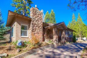 a stone house with a stone chimney at Cheyenne Chalet home in Round Hill