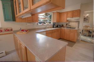 a kitchen with wooden cabinets and a counter top at Cheyenne Chalet home in Round Hill