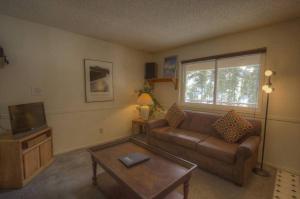 a living room with a couch and a tv at Heavenly Chairview Condo home in Stateline