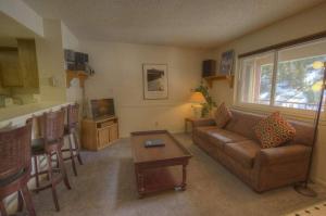 a living room with a couch and a table at Heavenly Chairview Condo home in Stateline