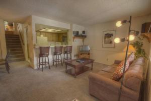 a living room with a couch and a table and a kitchen at Heavenly Chairview Condo home in Stateline