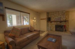 a living room with a couch and a fireplace at Heavenly Chairview Condo home in Stateline