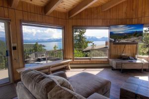 a living room with a couch and large windows at The Heights home in Zephyr Cove