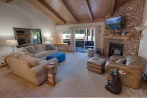 a living room with couches and a fireplace at Whispering Wood home in Incline Village