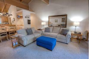 a living room with two couches and a mirror at Whispering Wood home in Incline Village