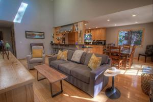 a living room with a couch and a kitchen at Gale Force Wind home in Incline Village