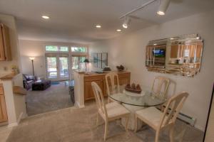 a kitchen and dining room with a glass table and chairs at Delightful McCloud condo in Incline Village