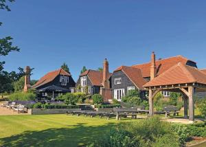 a group of houses with picnic tables in a park at Warren Lodges in Little Baddow