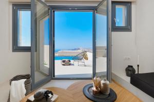 a room with a large window with a view of the ocean at M&D Stories in Pirgos