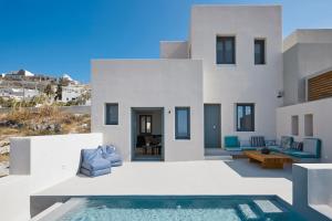 a villa with a swimming pool in front of a house at M&D Stories in Pirgos