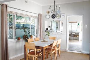 a kitchen and dining room with a table and chairs at Leisure Isle Seaside Cottage in Knysna