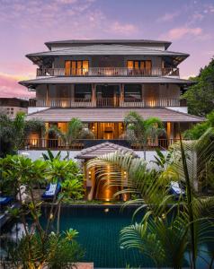 a building with a pool in front of it at Anamiva, Goa - AM Hotel Kollection in Anjuna