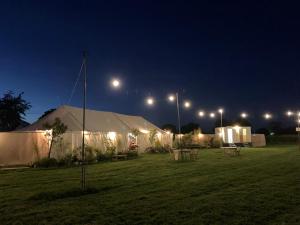 a large tent in a field at night at Fred's Yurts at Hay Festival in Hay-on-Wye