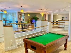 a pool table in the middle of a room at Holiday Inn Calais Coquelles, an IHG Hotel in Coquelles