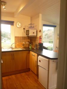 a kitchen with a sink and a counter top at Whiteshell Chalets in The Mumbles