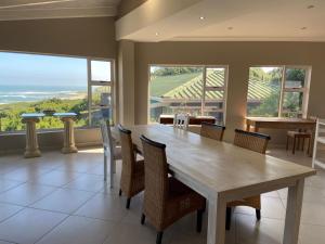 a large dining room with a table and chairs at Loerie Nest in Port Alfred