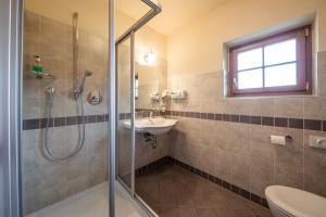 a bathroom with a shower and a sink at Hotel Seerast in Ultimo +21 photos