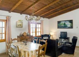 a living room with a dining room table and chairs at Can Garriga in Garriguella