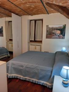 a bedroom with a bed and two windows at La Casina di Veggio in Perugia