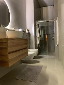a bathroom with a sink and a toilet and a shower at Bohemian House in Milan