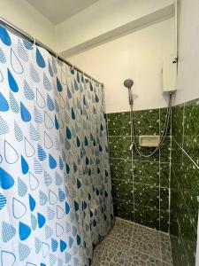 a shower with a blue and white shower curtain at Baan Rachaya in Chiang Mai