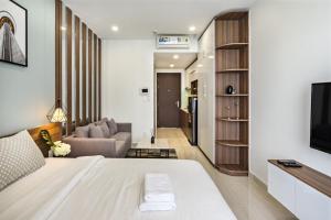 a bedroom with a bed and a living room at Genius Apartment RiverGate Free Pool in Ho Chi Minh City