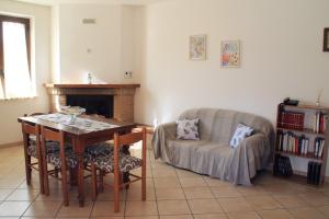 a living room with a table and a chair and a couch at La casetta di Rosa in Montefranco