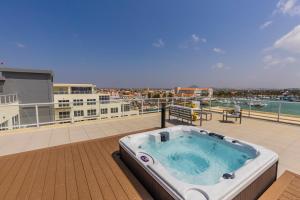 a hot tub on the roof of a building at Hh-2Bdr413 - New Modern Apartment In Oceanfront Luxury Condo In Aruba! in Oranjestad