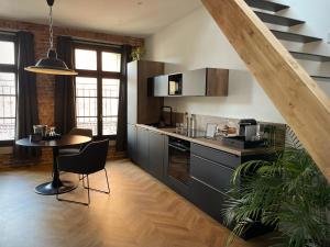 a kitchen with a table and a counter top at Ennéa - Jacuzzi & Luxury Suites in Perpignan
