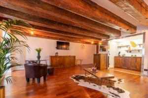 a living room with wooden floors and a table at Aurelia Luxury - Piazza delle Erbe in Verona