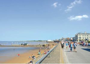 a group of people on a beach near the water at Lakeside Holiday Park in Burnham on Sea