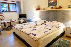 a bedroom with a bed and a table at Ferienwohnung Timmy in Lubmin +14 photos